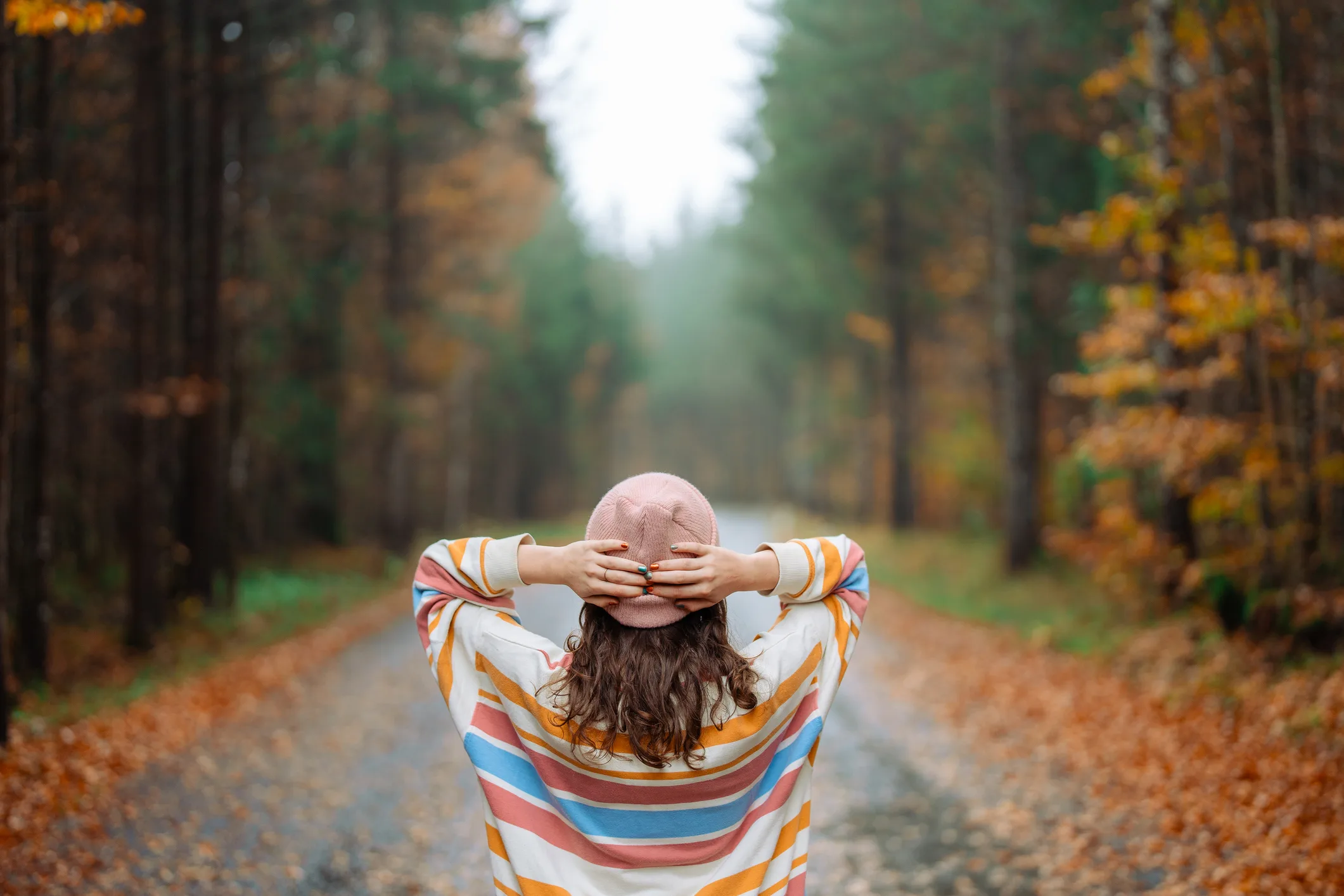 Woman walking in the autumn forest after the rain